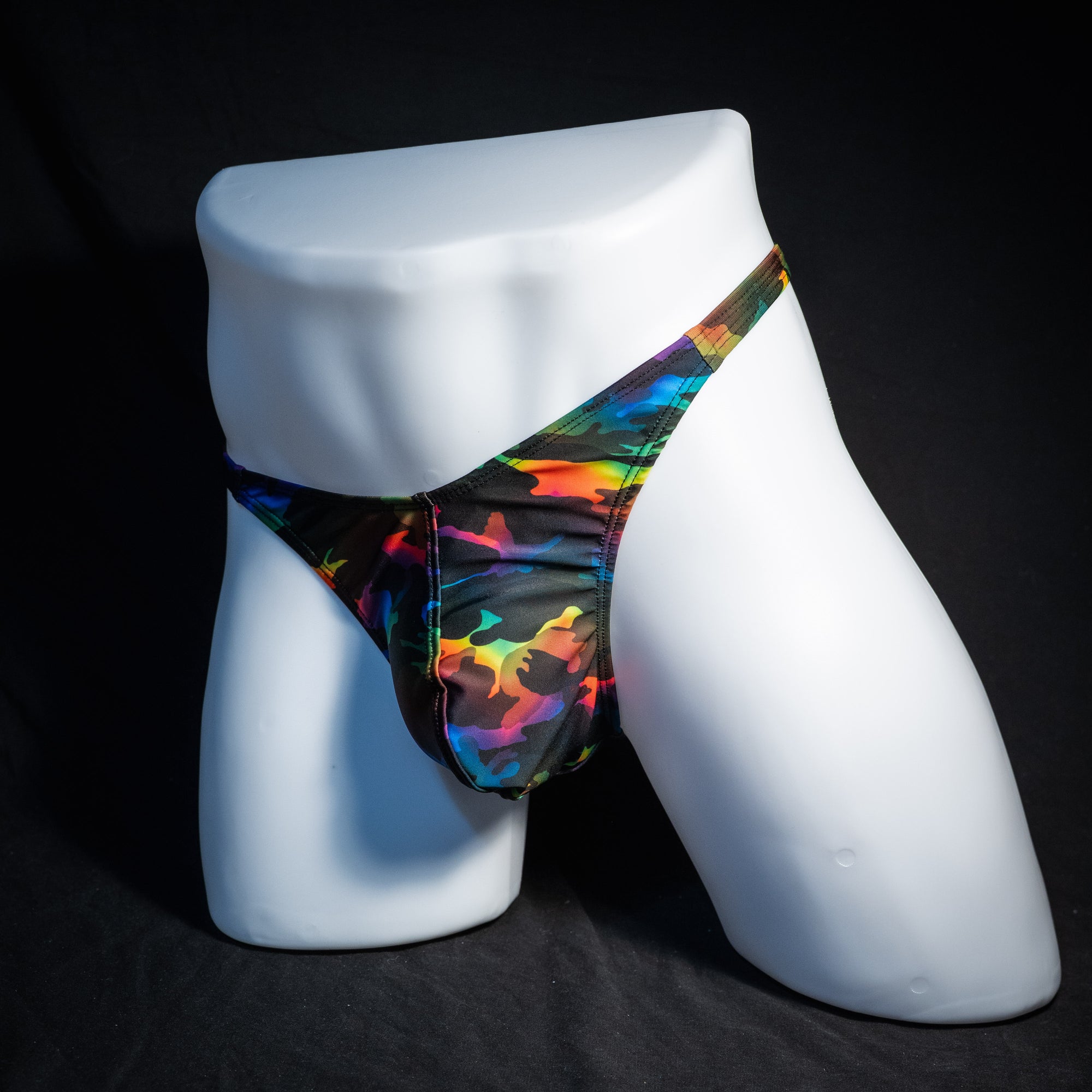 Men's rainbow camo thong underwear, classic cut, front view.
