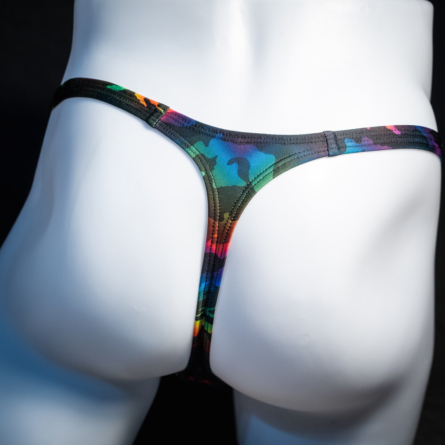 Men's rainbow camo thong underwear, classic cut, rear view.