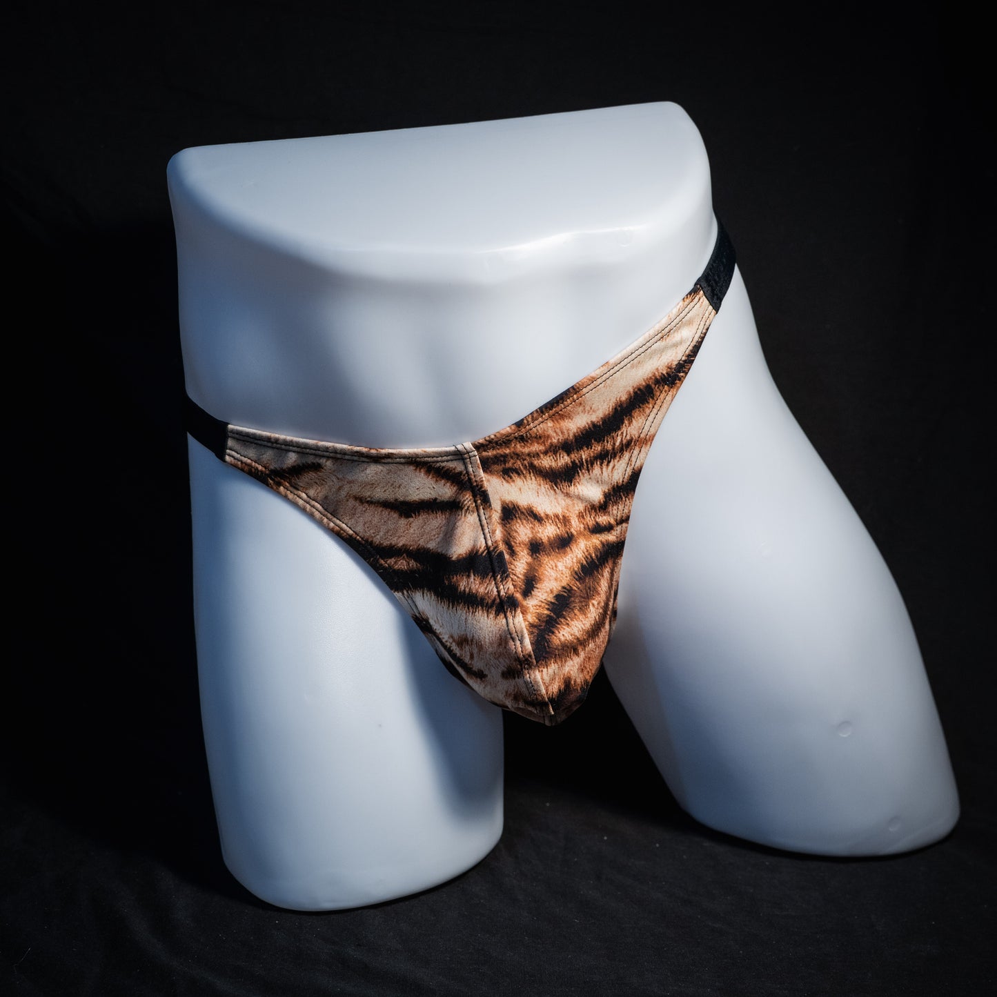 Men's tiger stripe thong underwear, classic cut, front view.