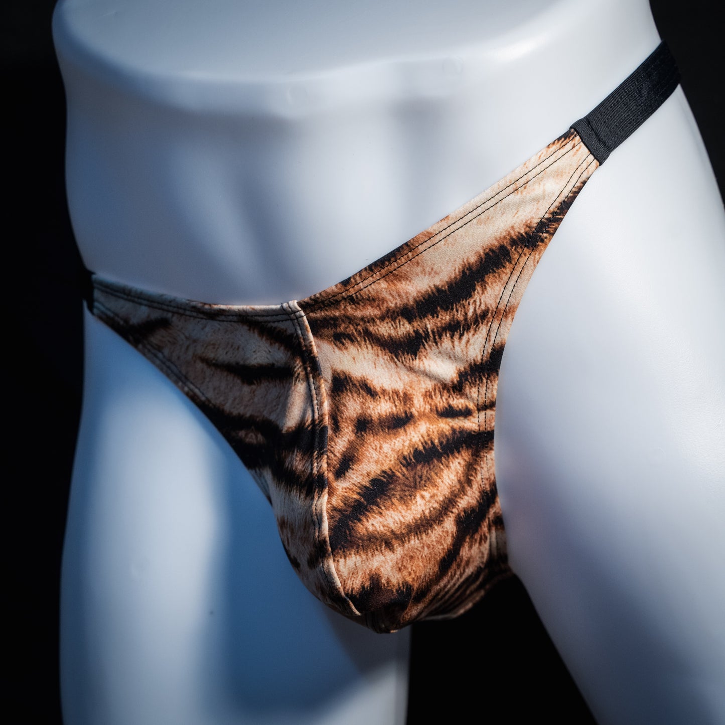 Men's tiger stripe thong underwear, classic cut, front view.