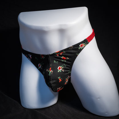 Men's red and black floral thong underwear, classic cut, front view.