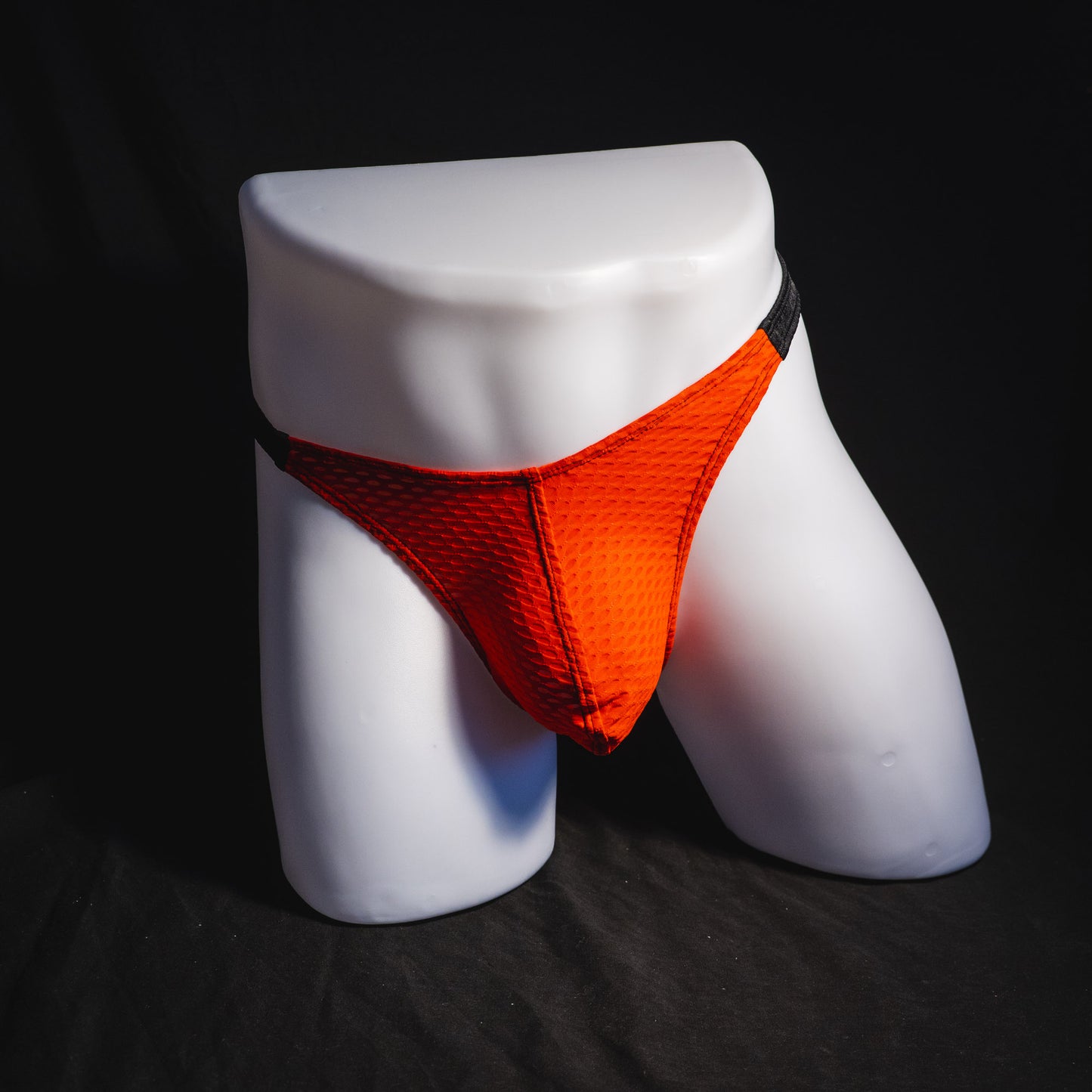 Men's red and black athletic mesh thong underwear, classic cut, full front view.