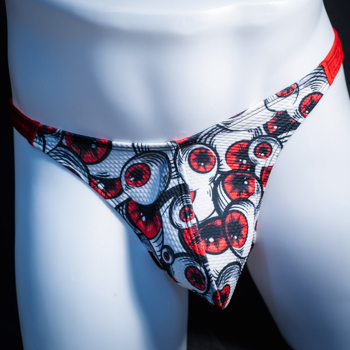 Men's red eyeball thong underwear, classic cut, front view.