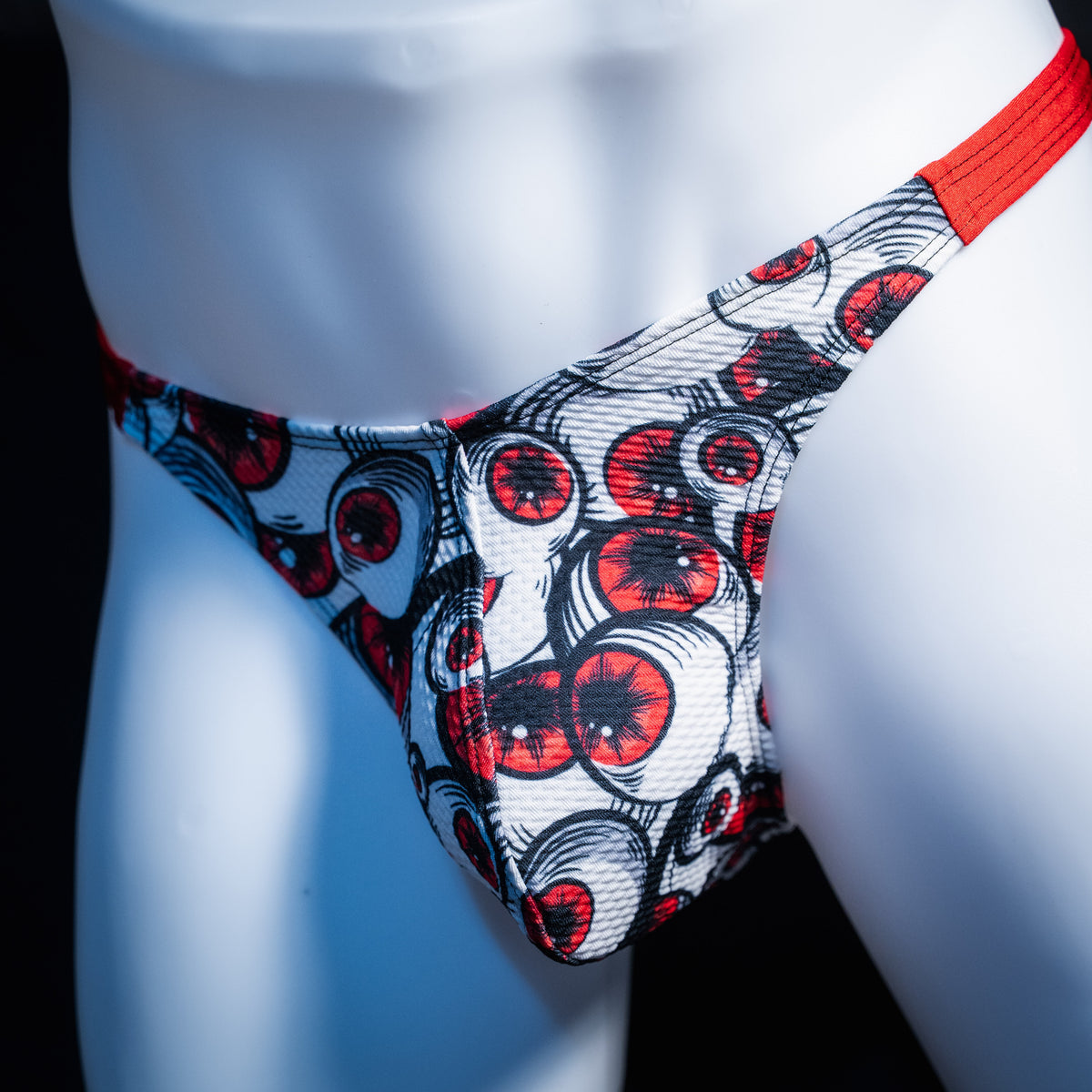 Men's red eyeball thong underwear, classic cut, front view.