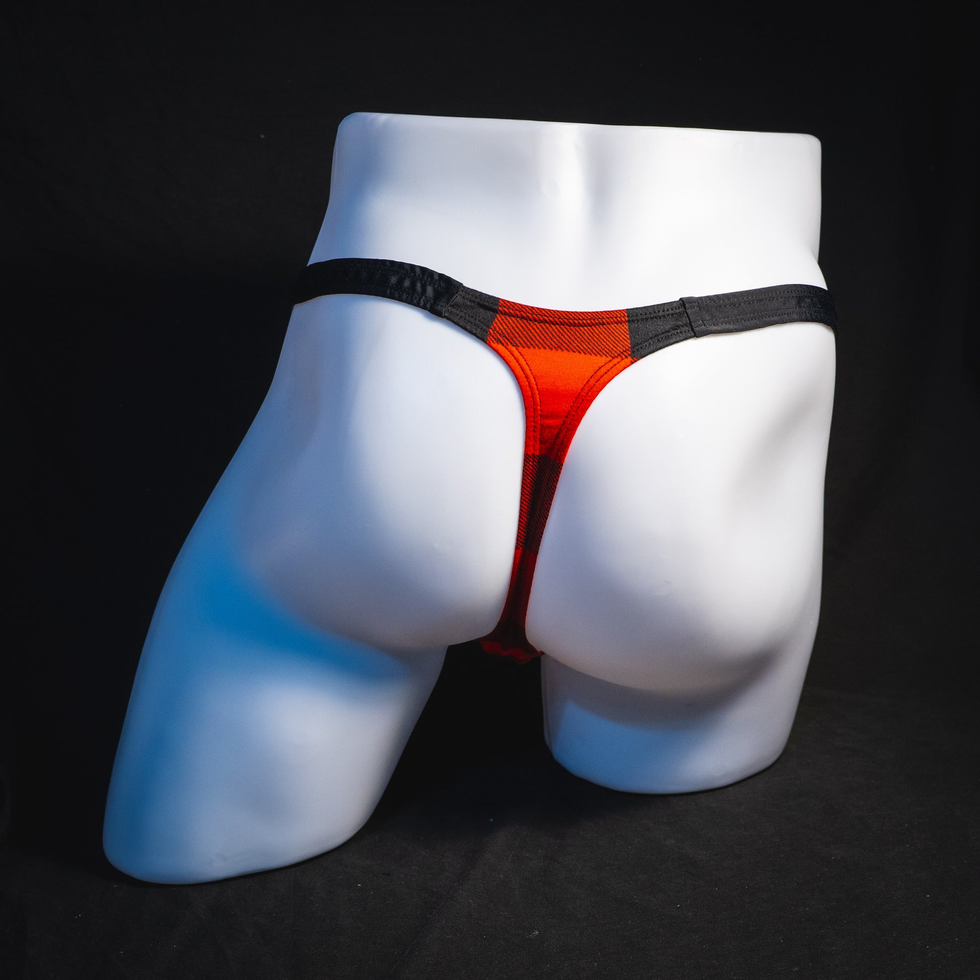 Men's red plaid with black straps thong underwear, classic cut, full rear view.