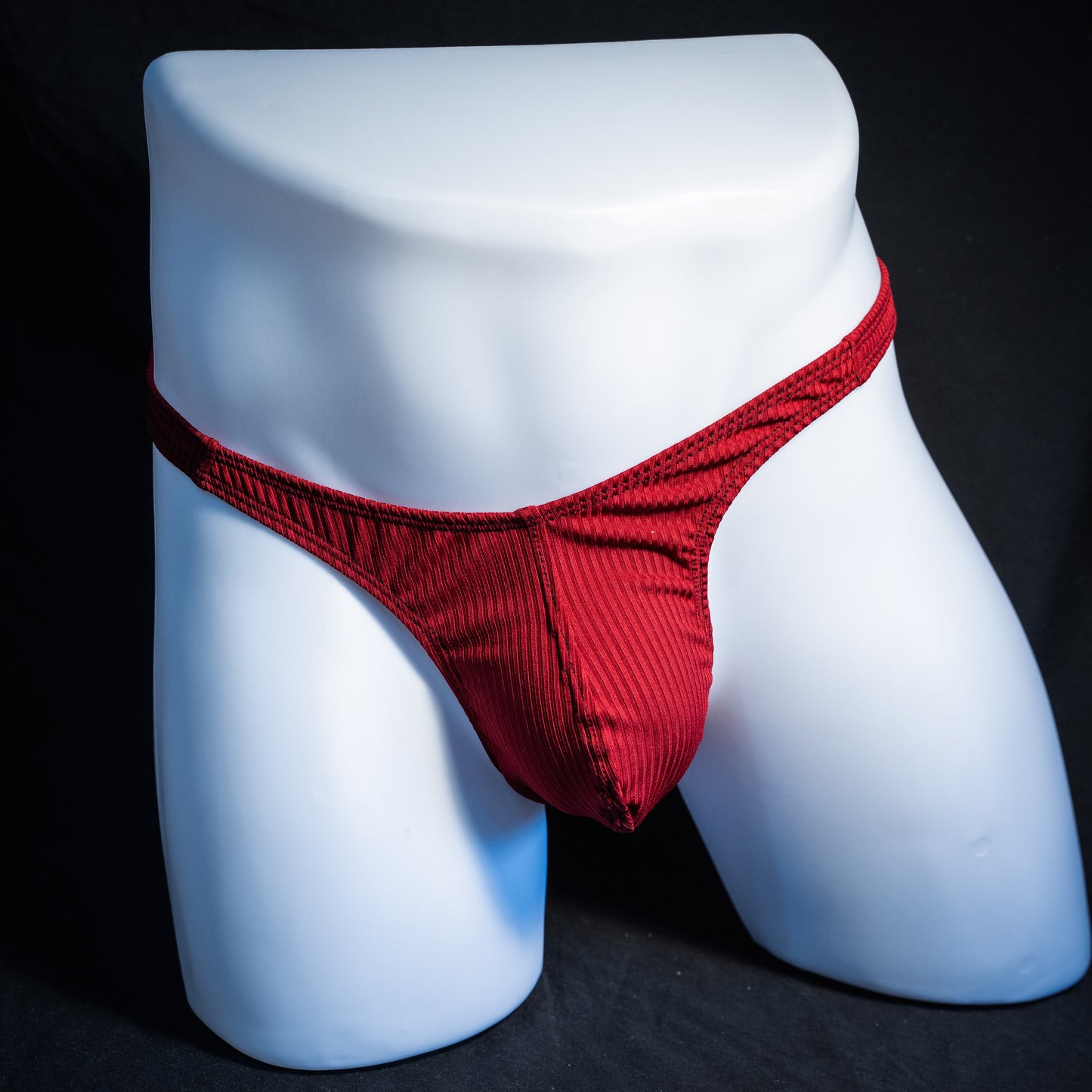 Men's ribbed red thong underwear, slim cut, front view.