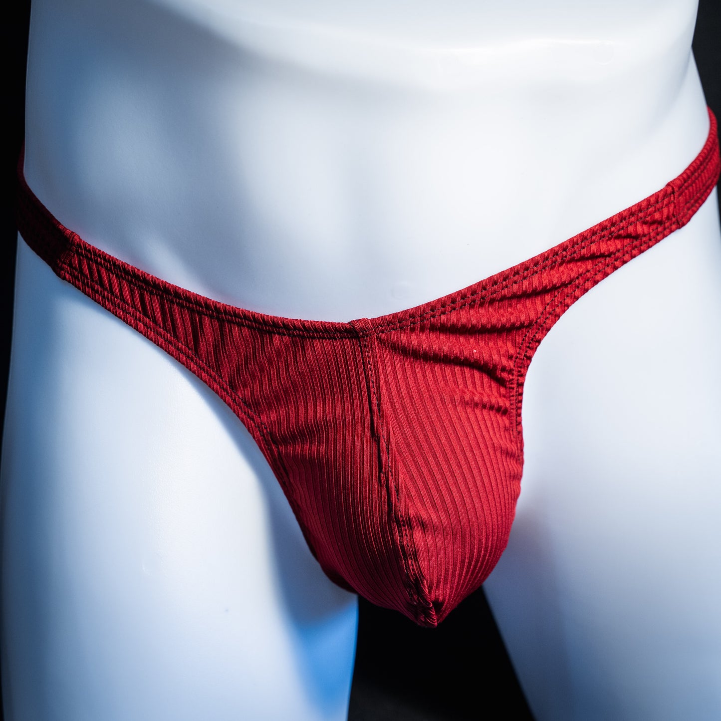 Men's ribbed red thong underwear, slim cut, front view.