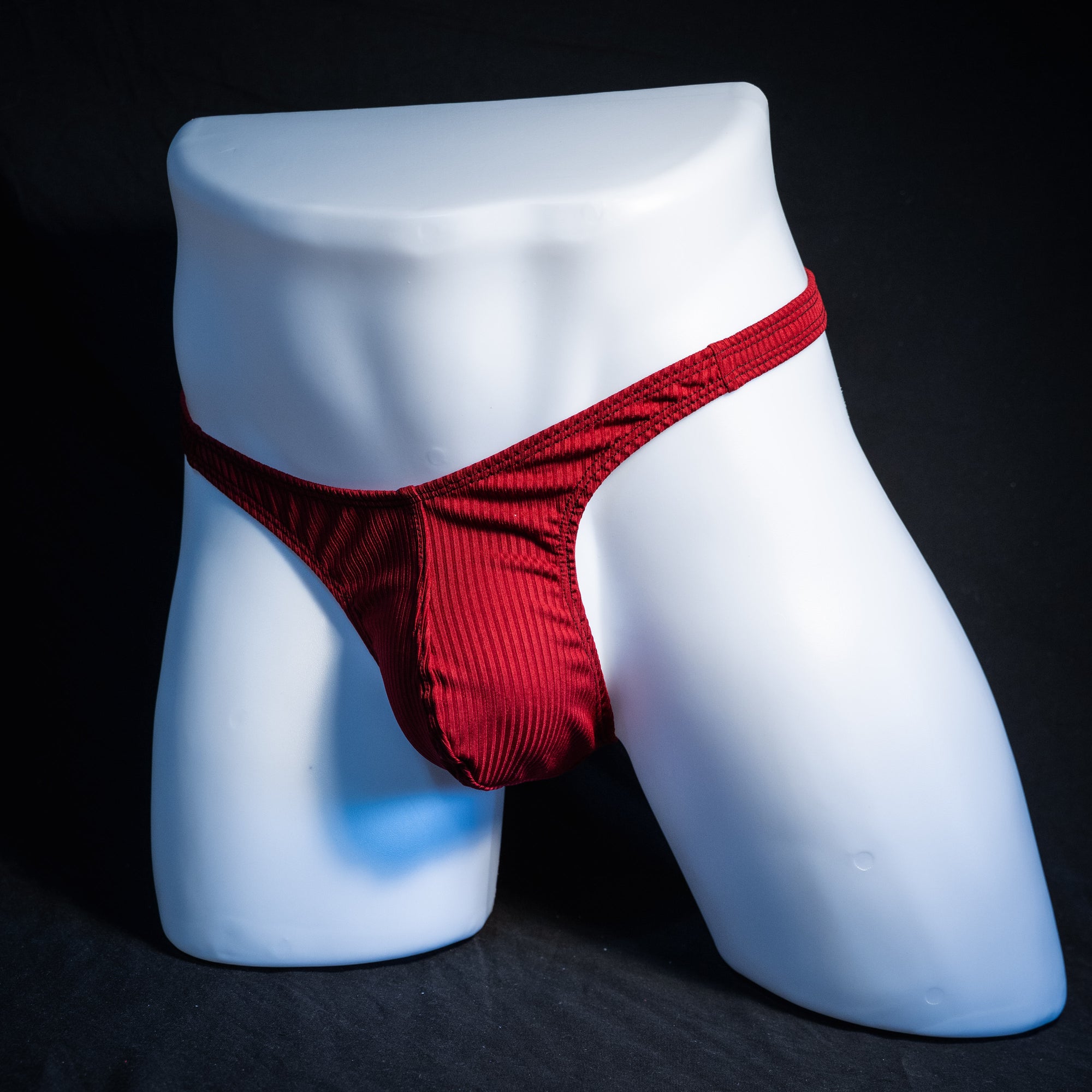 Men's ribbed red thong underwear, slim cut, front view.