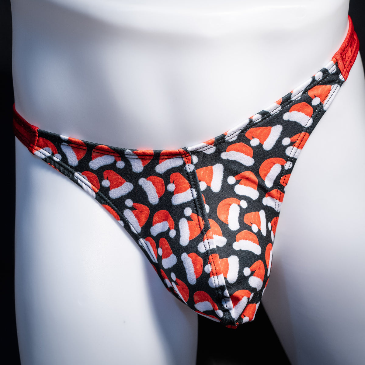 Men's red Santa hats, Christmas themed thong underwear, classic cut, front view.