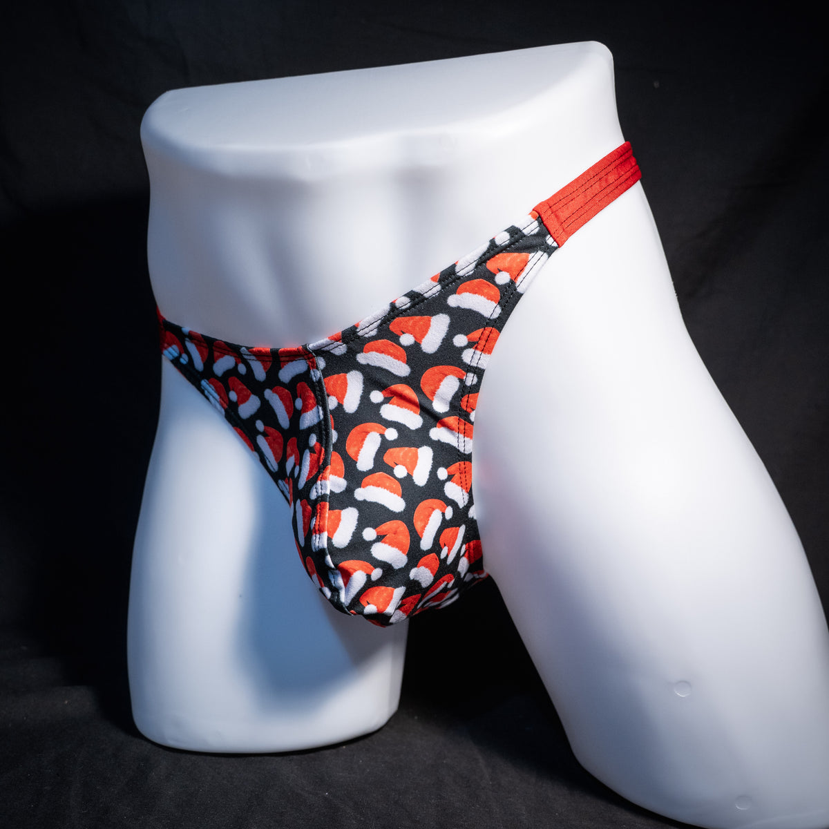 Men's red Santa hats, Christmas themed thong underwear, classic cut, front view.