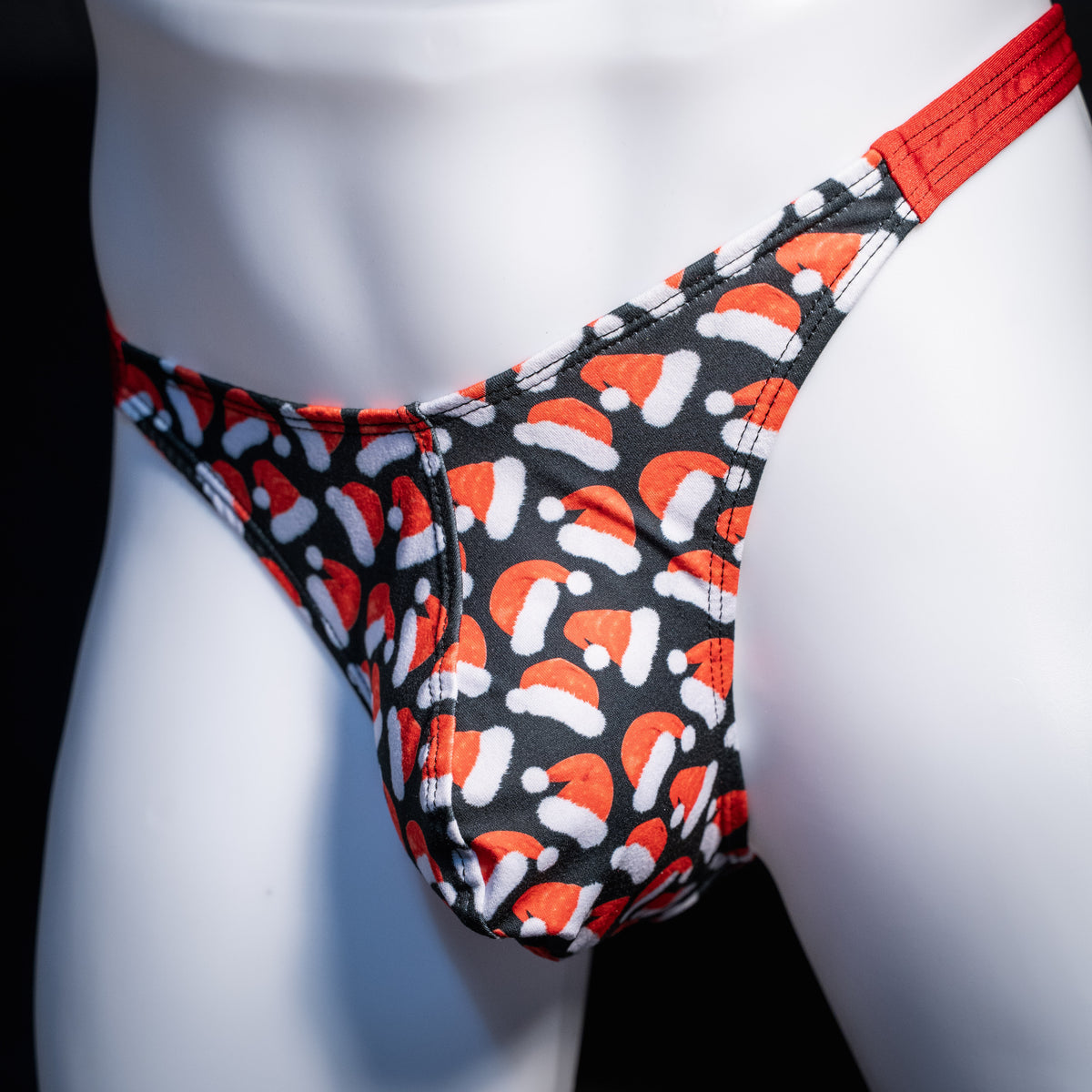 Men's red Santa hats, Christmas themed thong underwear, classic cut, front view.