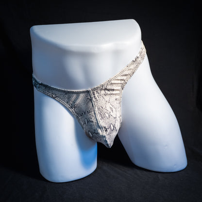 Men's beige snakeskin thong underwear, ribbed fabric, slim cut, front view.