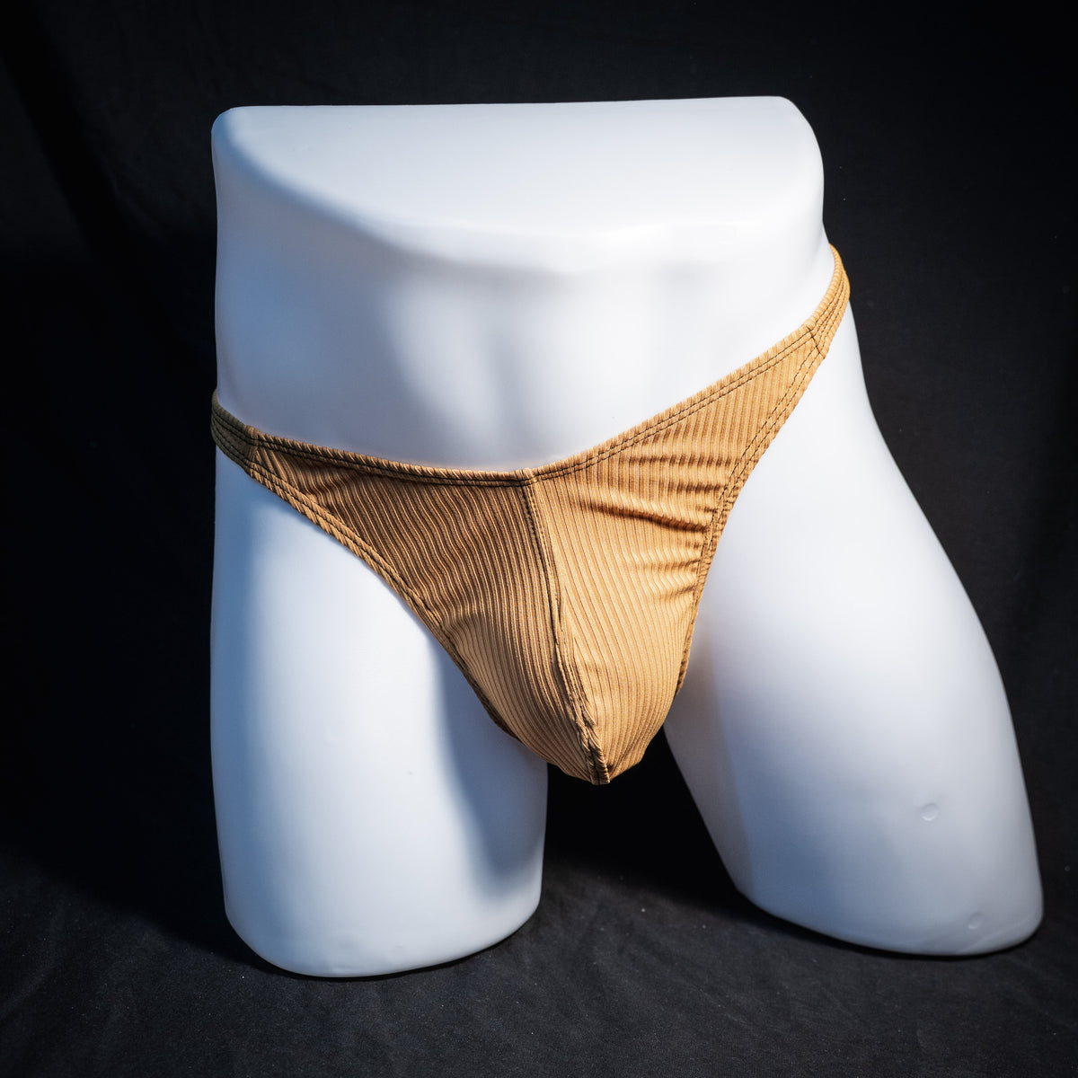 Men's ribbed gold thong underwear, classic cut, front view.