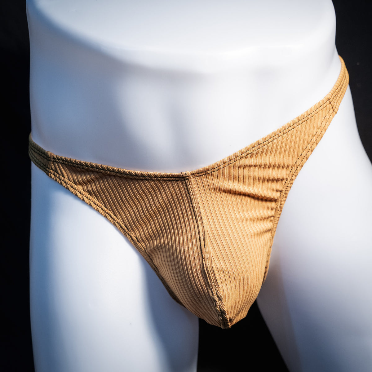 Men's ribbed gold thong underwear, classic cut, front view.