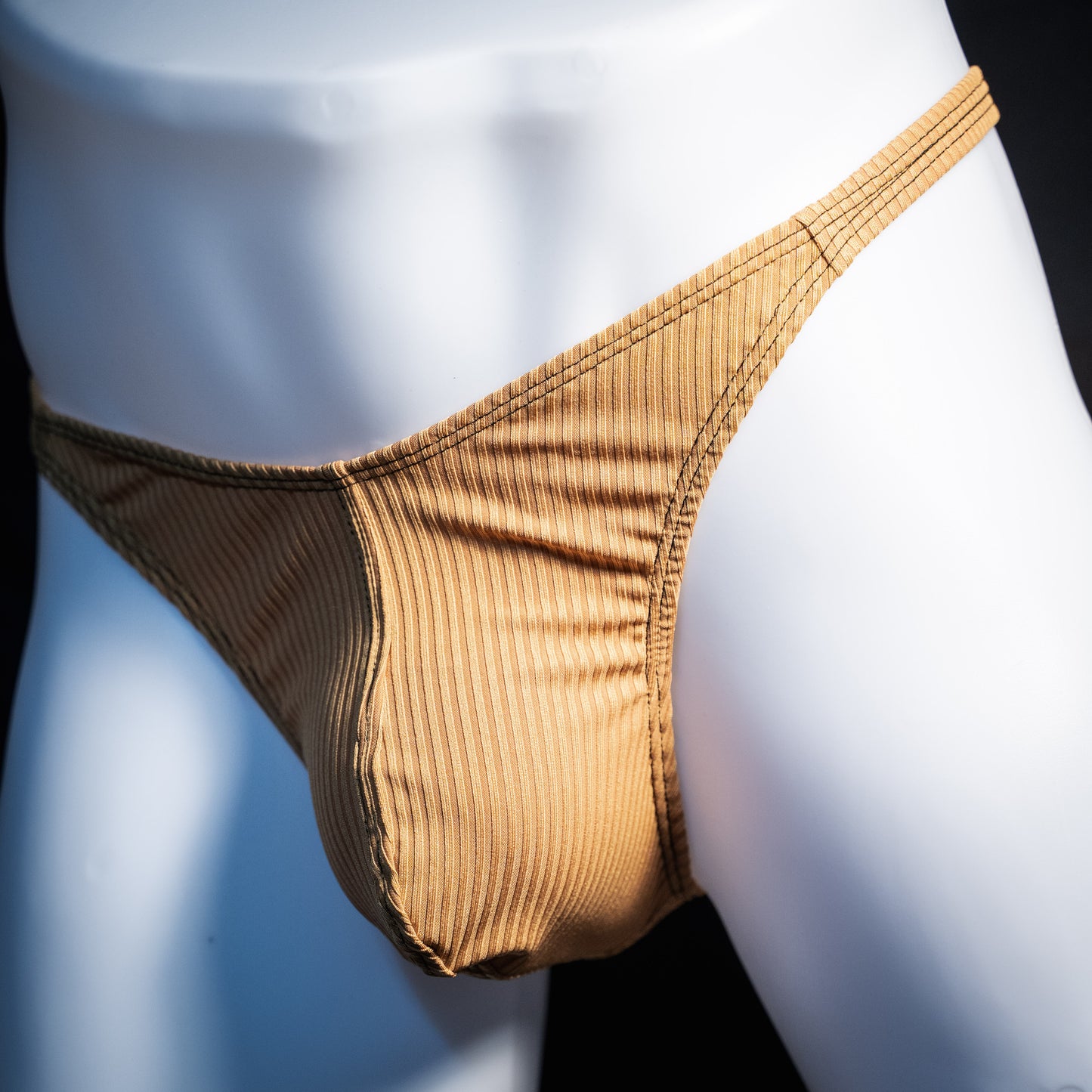 Men's ribbed gold thong underwear, classic cut, front view.