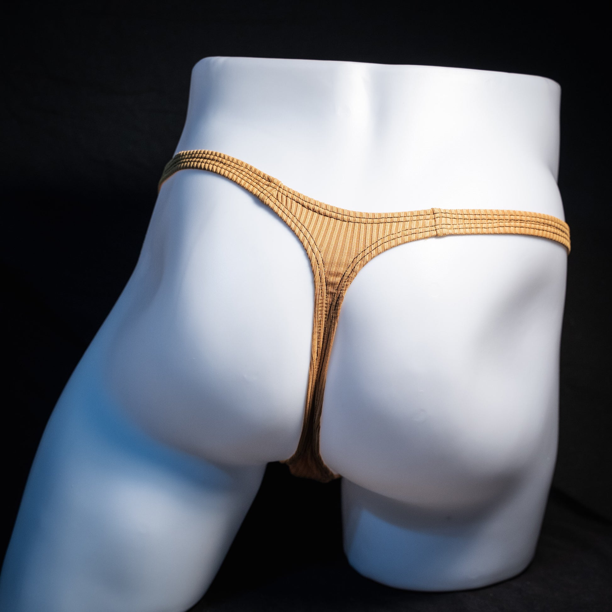 Men's ribbed gold thong underwear, classic cut, rear view.