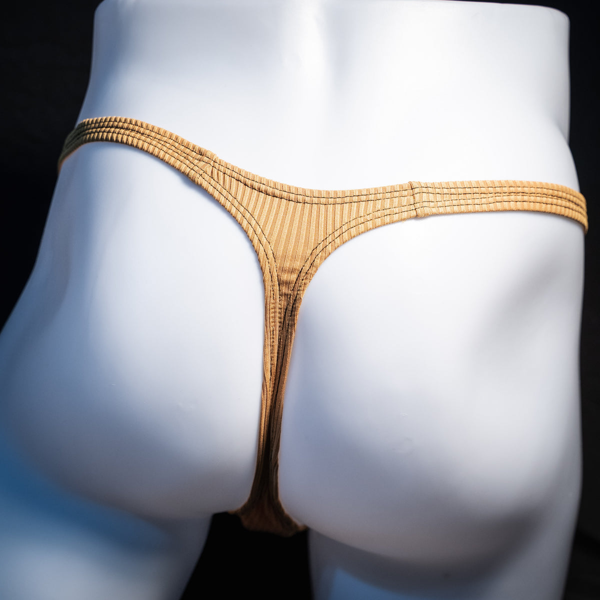 Men's ribbed gold thong underwear, classic cut, rear view.