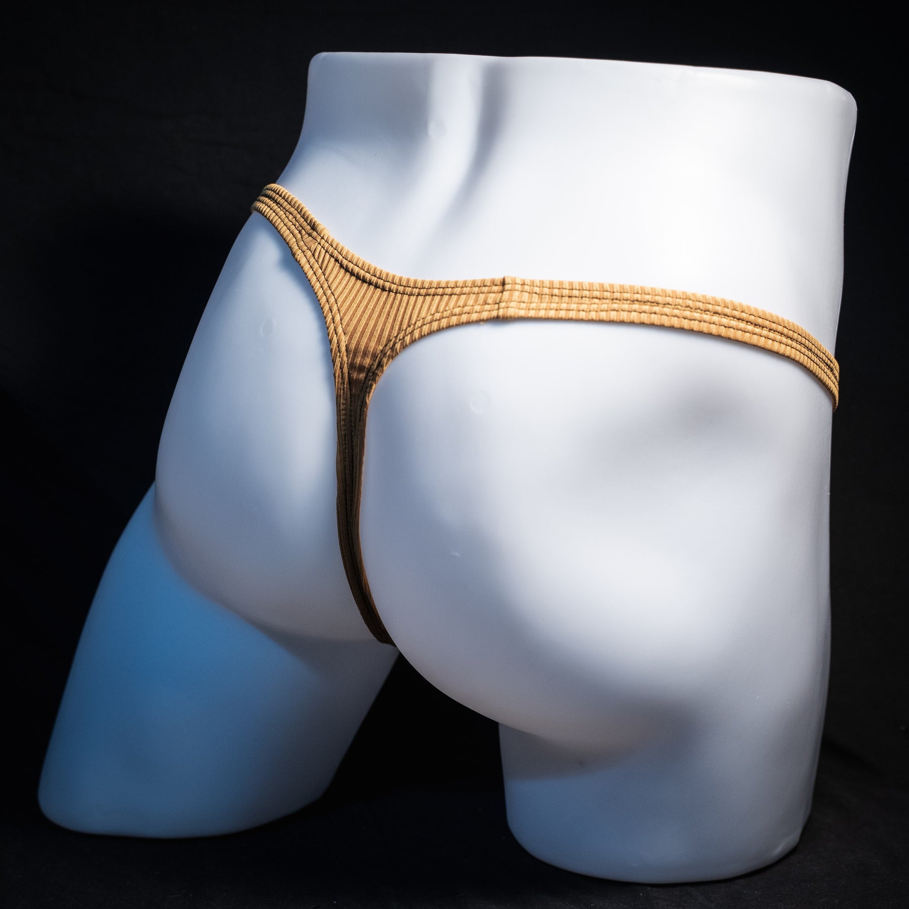 Men's ribbed gold thong underwear, classic cut, rear view.