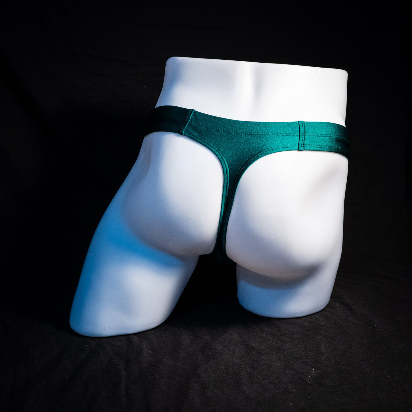 Men's forest green thong underwear, full rear view.