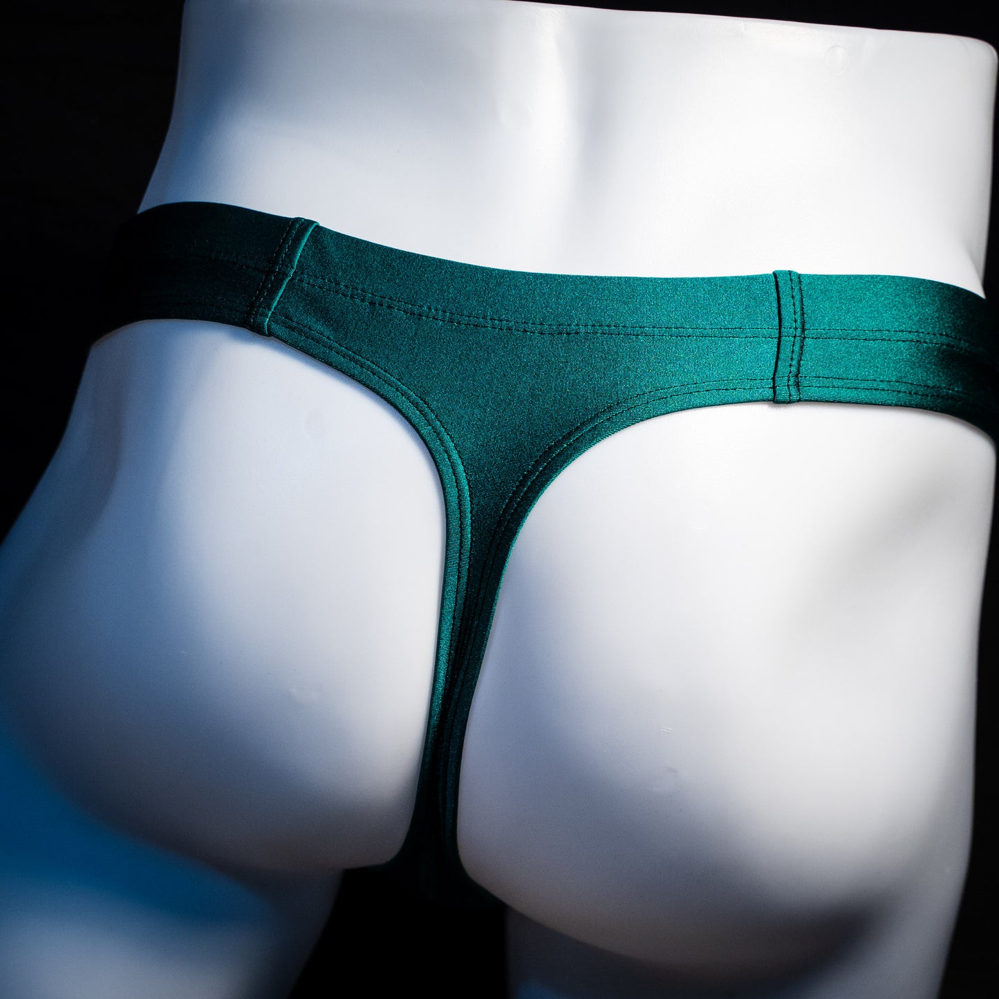 Men's forest green thong underwear, rear view.