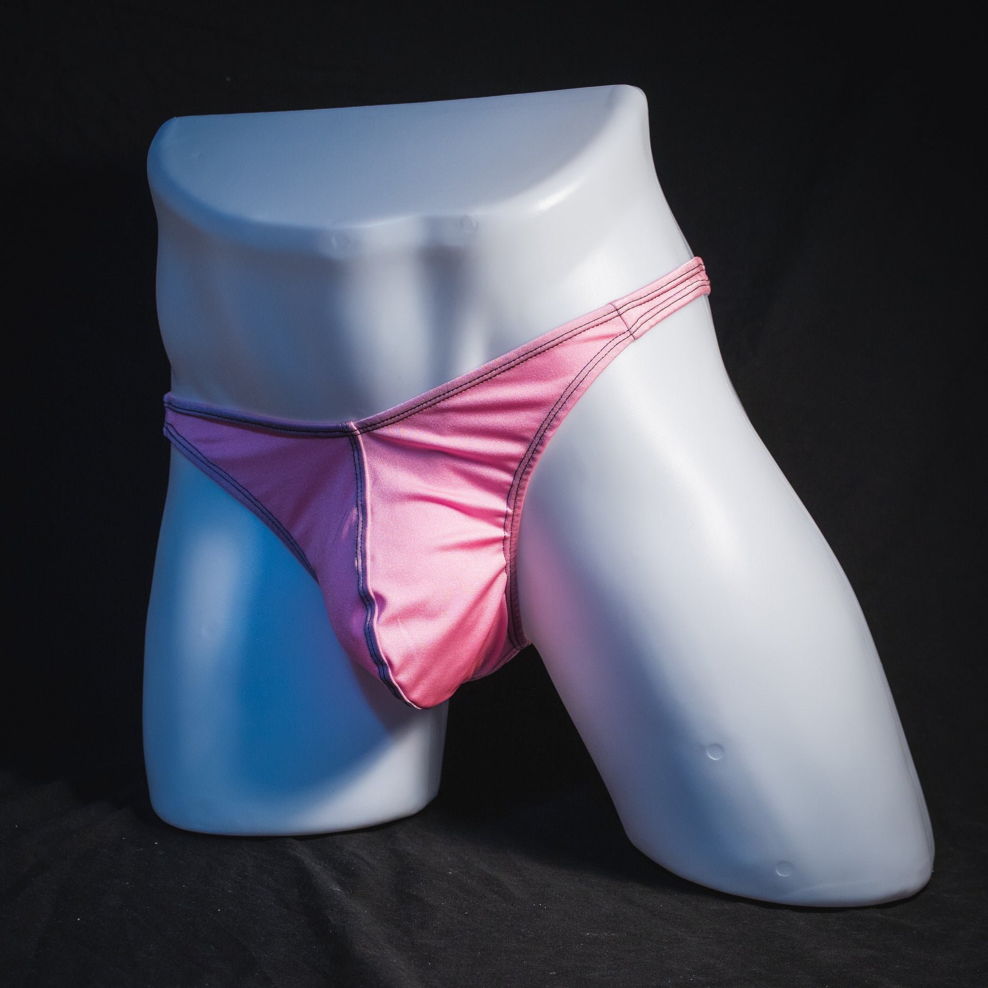 Men's rose pink thong underwear, classic cut, full angled front view.