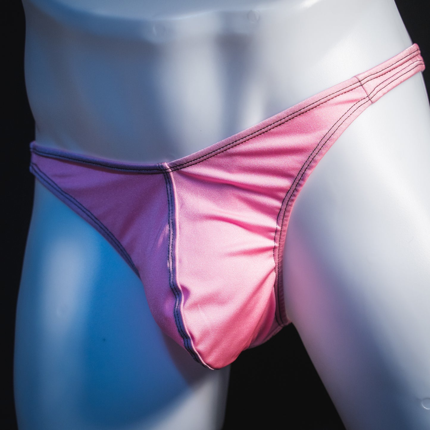 Men's rose pink thong underwear, classic cut, angled front view.