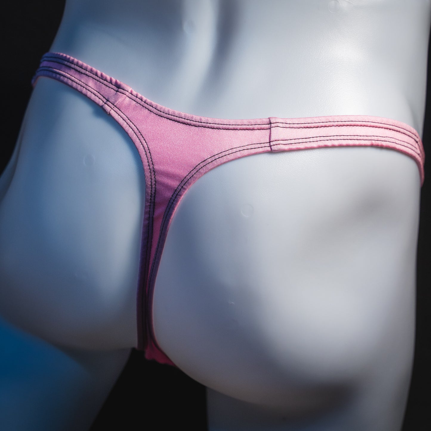 Men's rose pink thong underwear, classic cut, rear view.