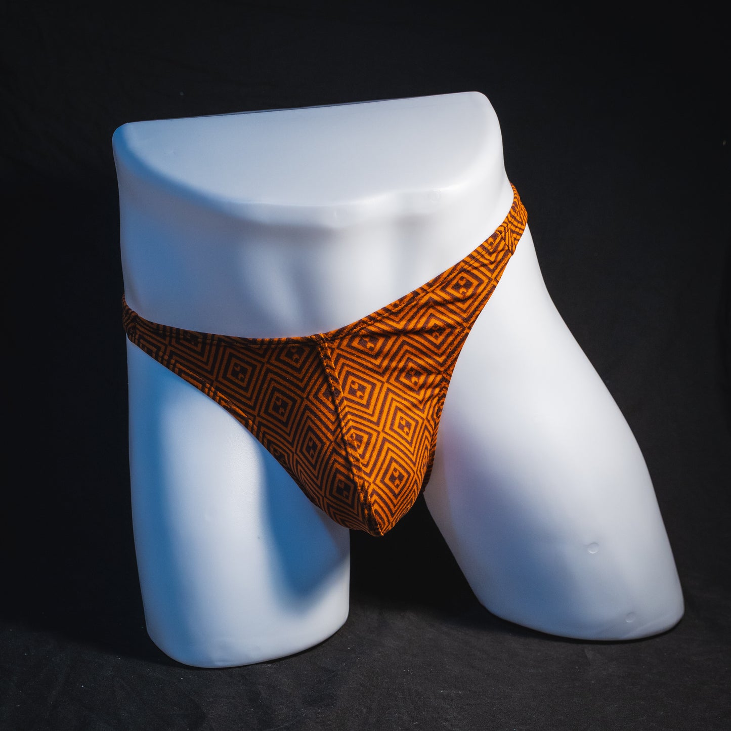 Men's geometric rust thong underwear, classic cut, full front view.