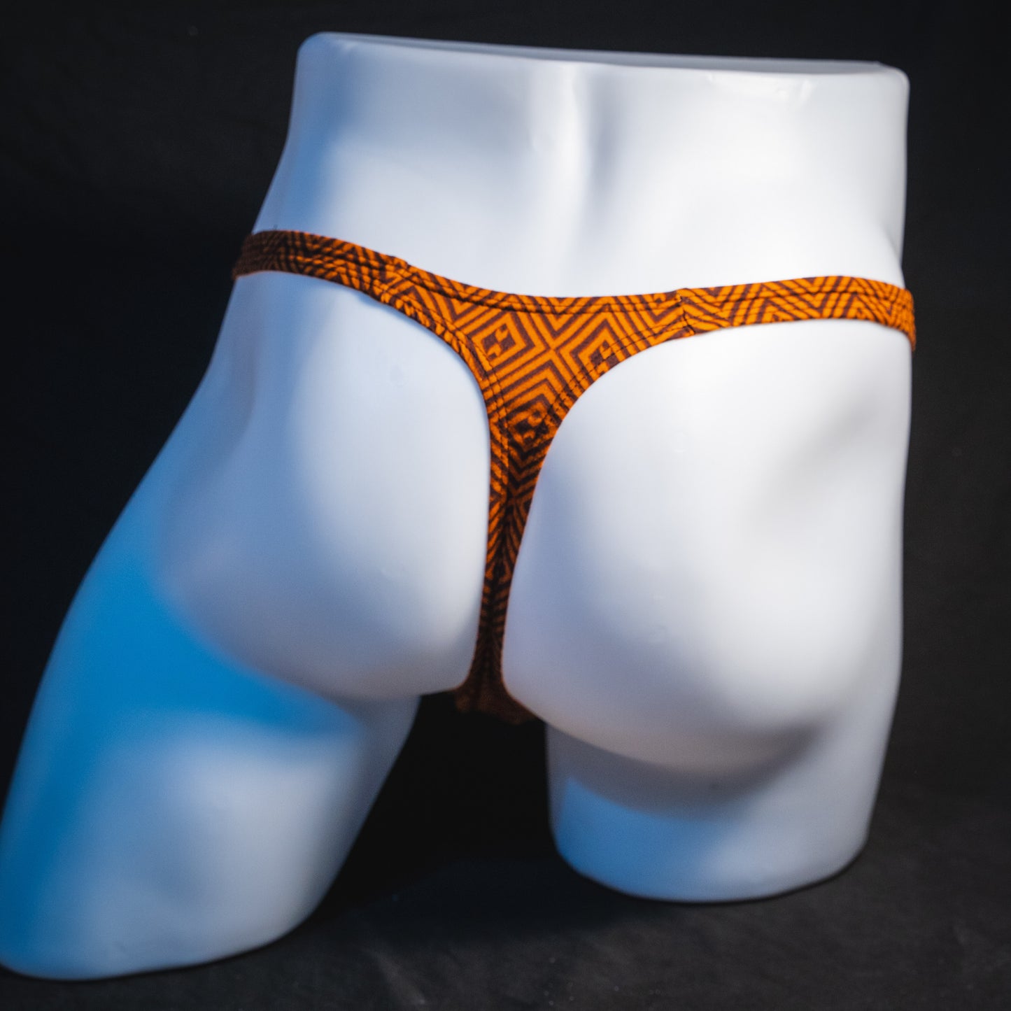 Men's geometric rust thong underwear, classic cut, full rear view.
