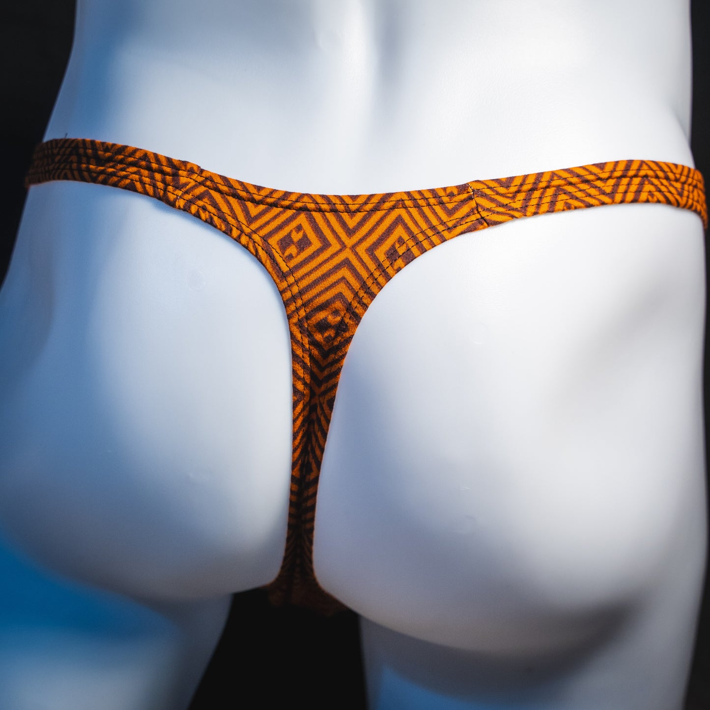 Men's geometric rust thong underwear, classic cut, rear view.