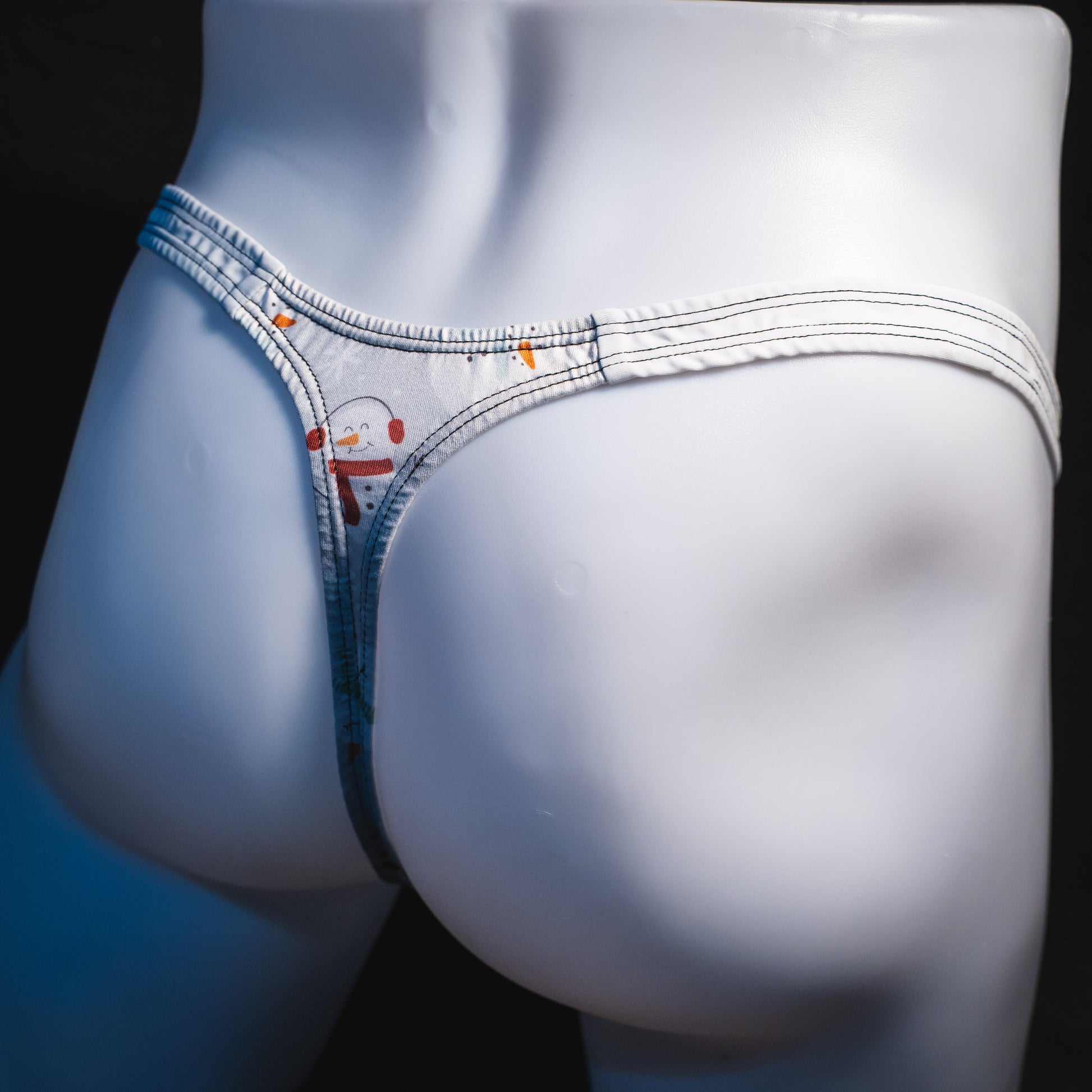 Men's snowmen thong underwear, classic cut, angled rear view.