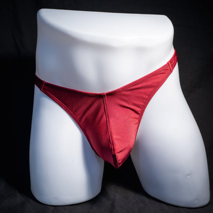Men's solid maroon red thong underwear, classic cut, front view.