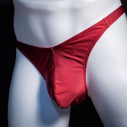 Men's solid maroon red thong underwear, classic cut, front view.