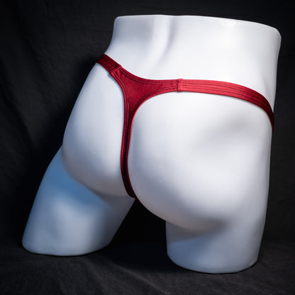 Men's solid maroon red thong underwear, classic cut, rear view.