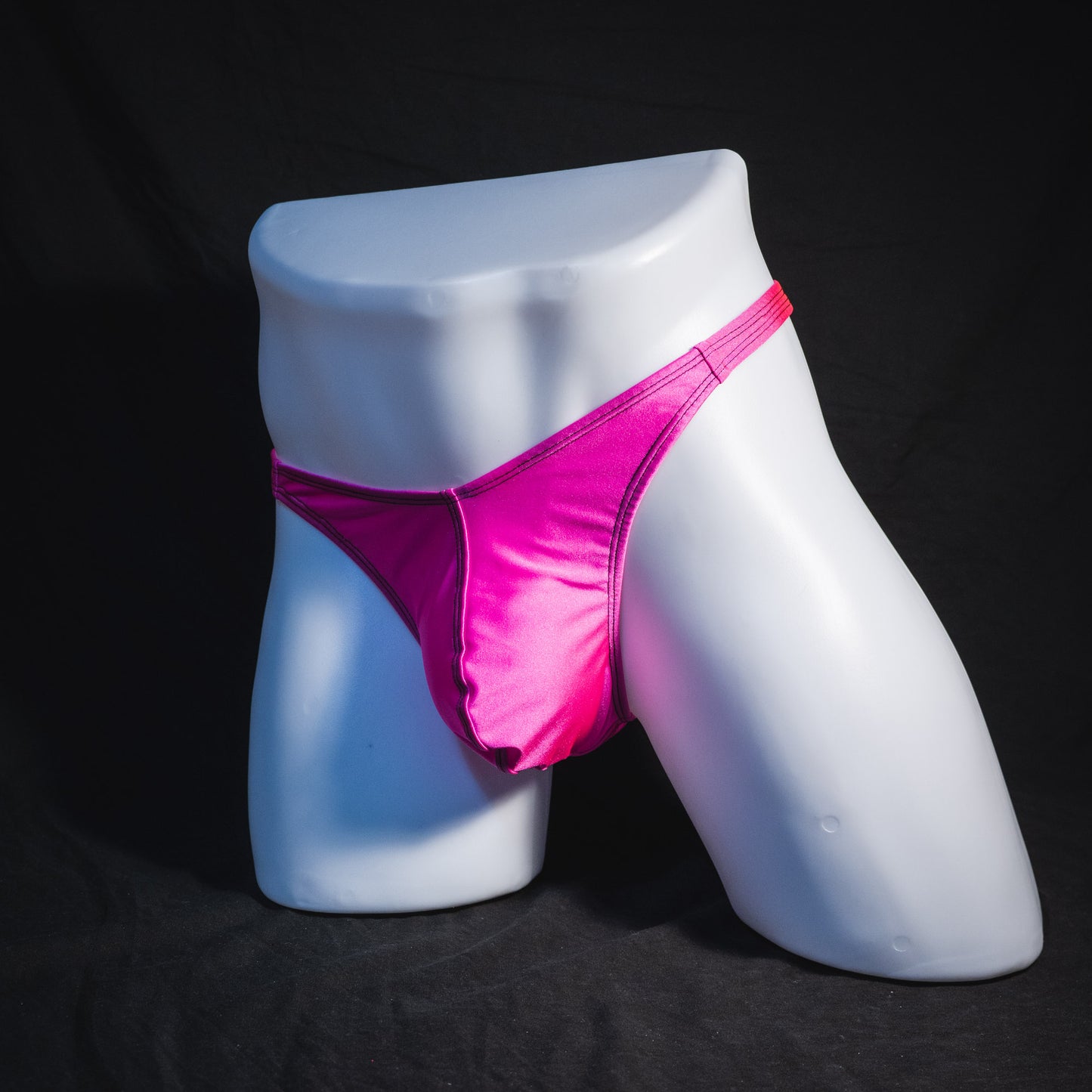 Men's solid pink thong underwear, classic cut, full angled front view.