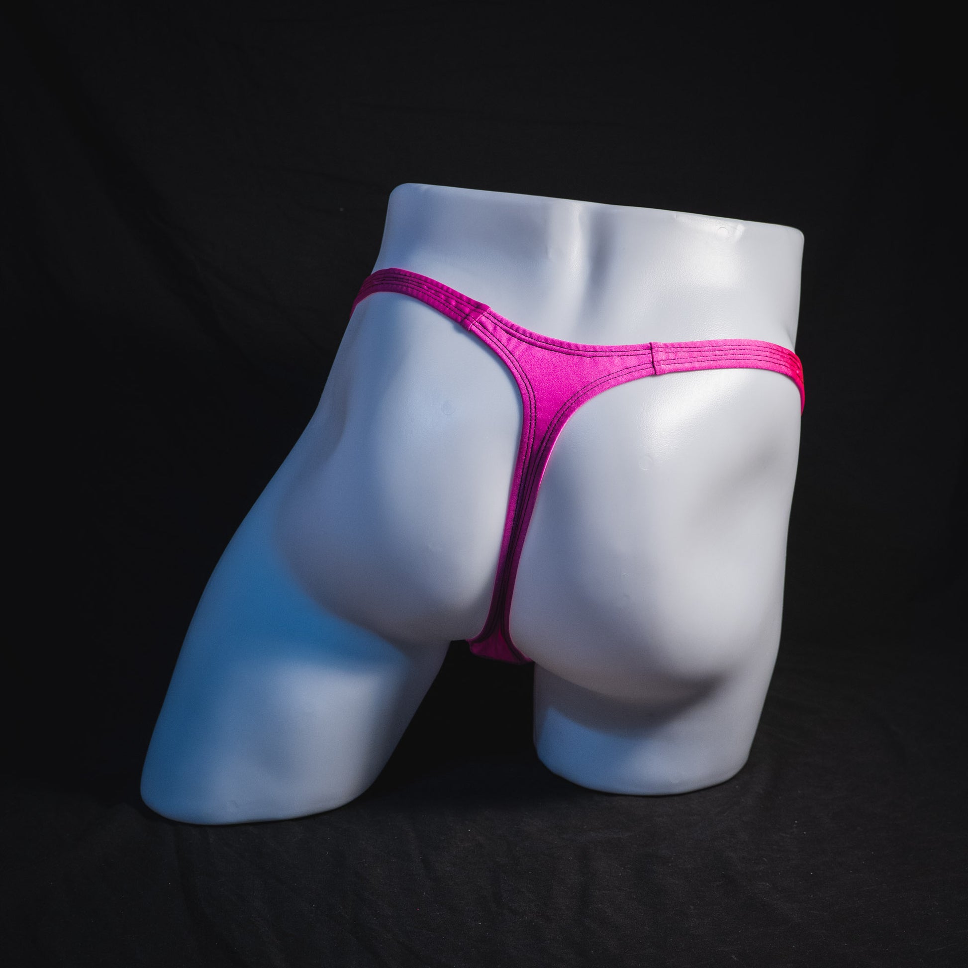 Men's solid pink thong underwear, classic cut, full rear view.