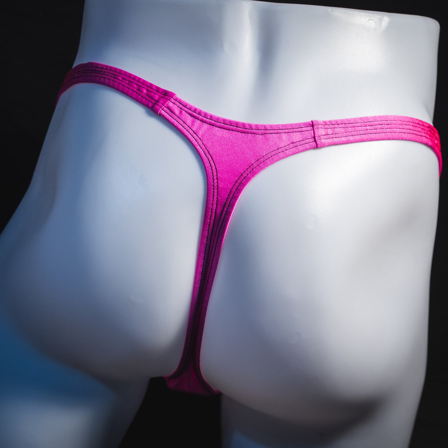 Men's solid pink thong underwear, classic cut, rear view.