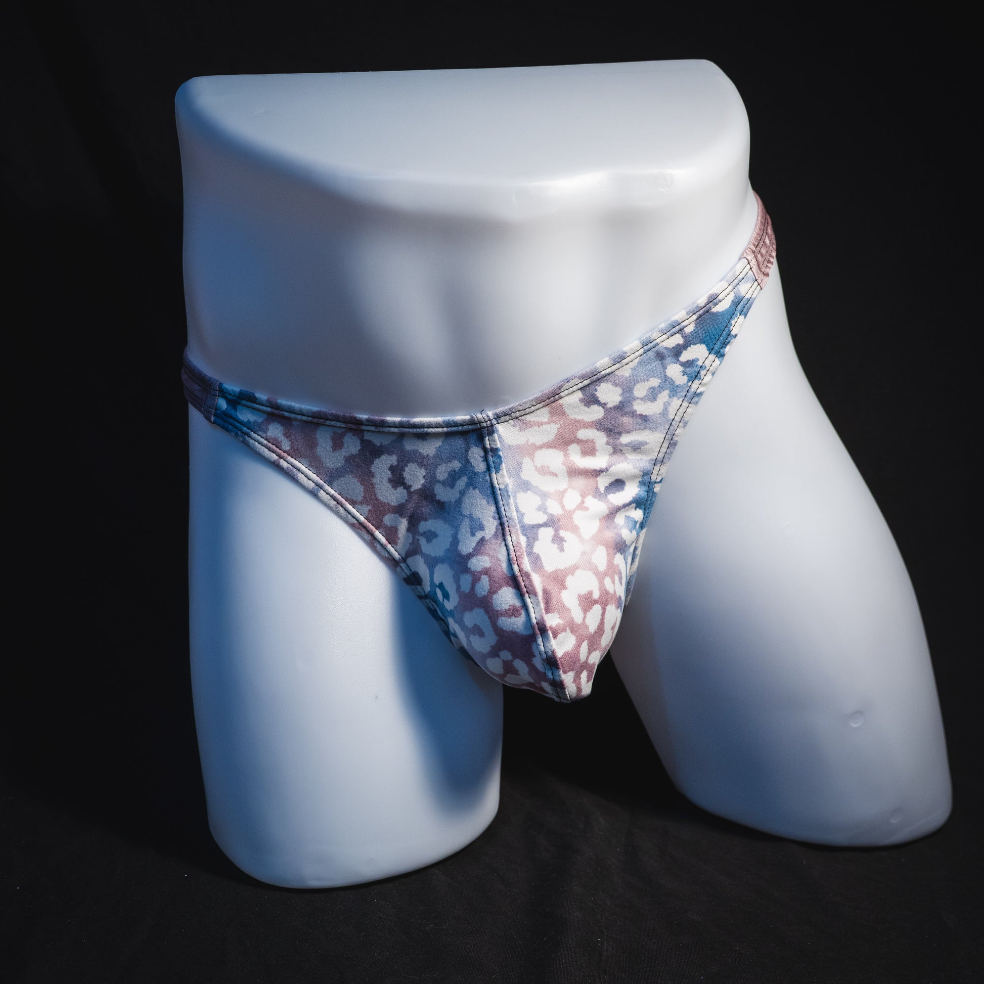 Men's purple and pink watercolor cheetah print thong underwear, classic cut, full front view.