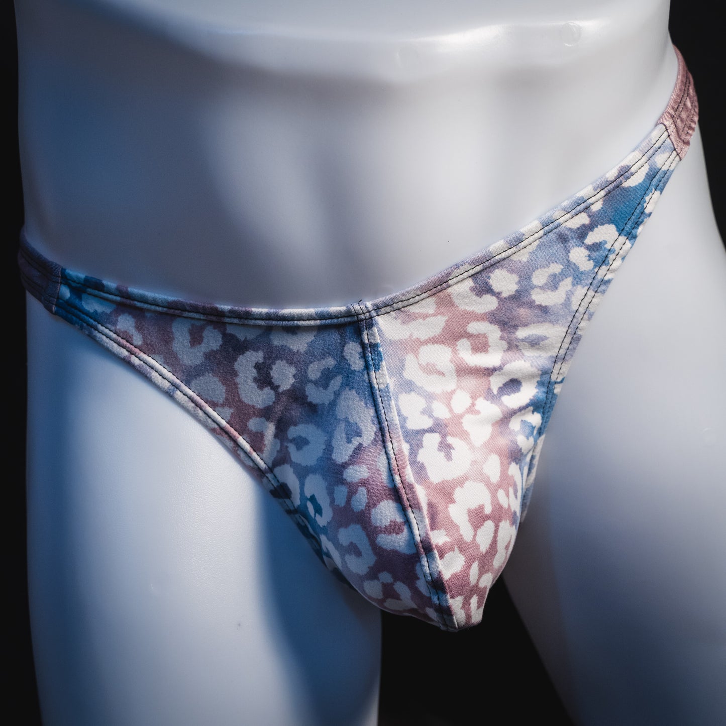 Men's purple and pink watercolor cheetah print thong underwear, classic cut, front view.