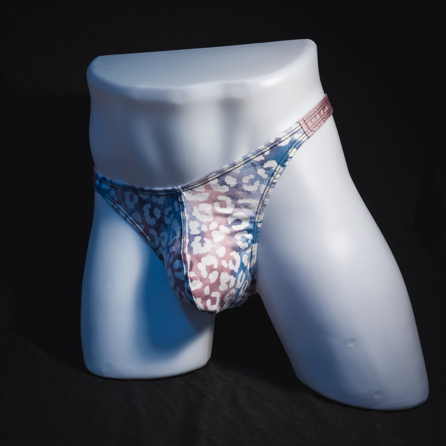 Men's purple and pink watercolor cheetah print thong underwear, classic cut, full angled front view.