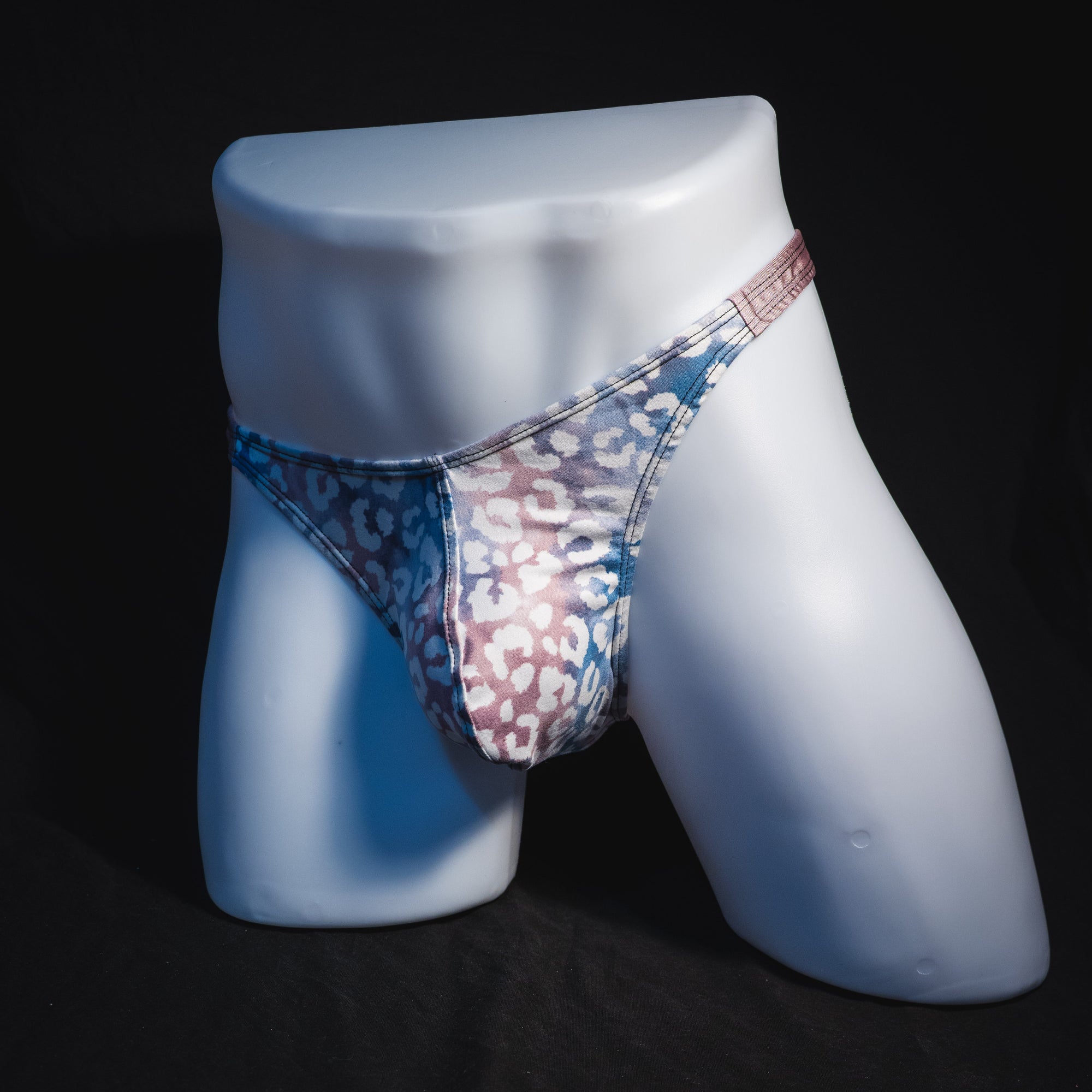 Men's purple and pink watercolor cheetah print thong underwear, classic cut, full angled front view.