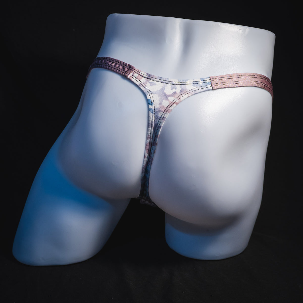 Men's purple and pink watercolor cheetah print thong underwear, classic cut, full rear view.