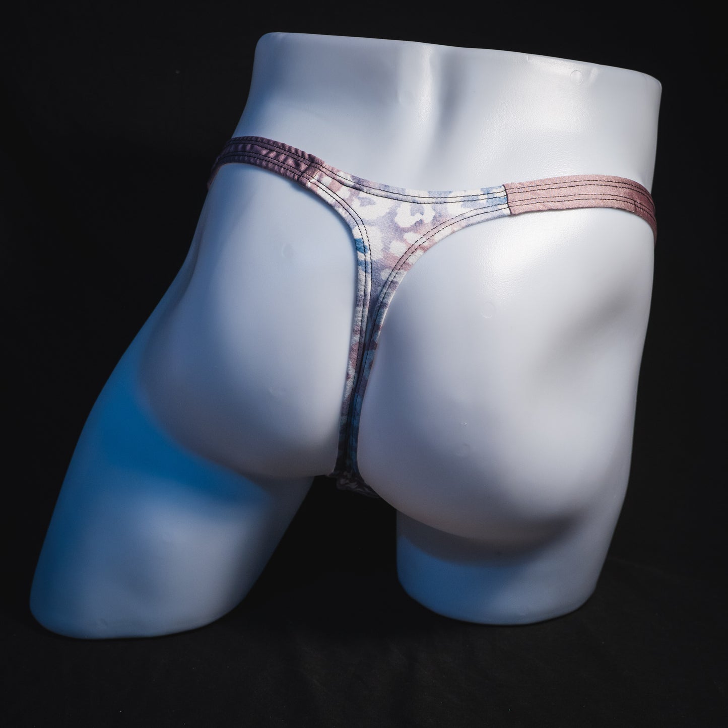 Men's purple and pink watercolor cheetah print thong underwear, classic cut, full rear view.