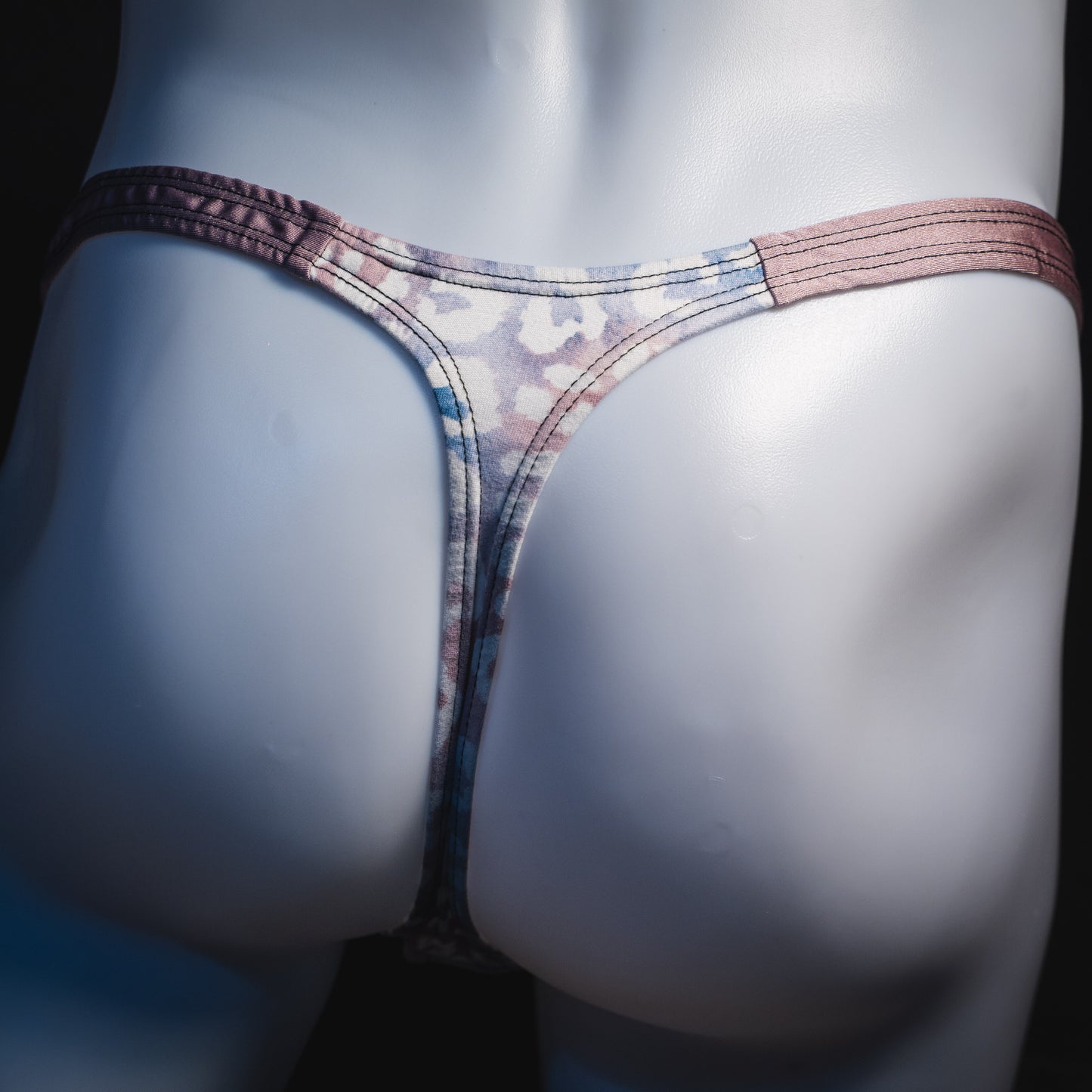 Men's purple and pink watercolor cheetah print thong underwear, classic cut, rear view.