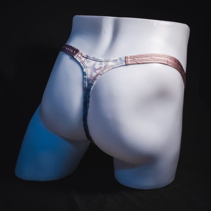 Men's purple and pink watercolor cheetah print thong underwear, classic cut, full angled rear view.