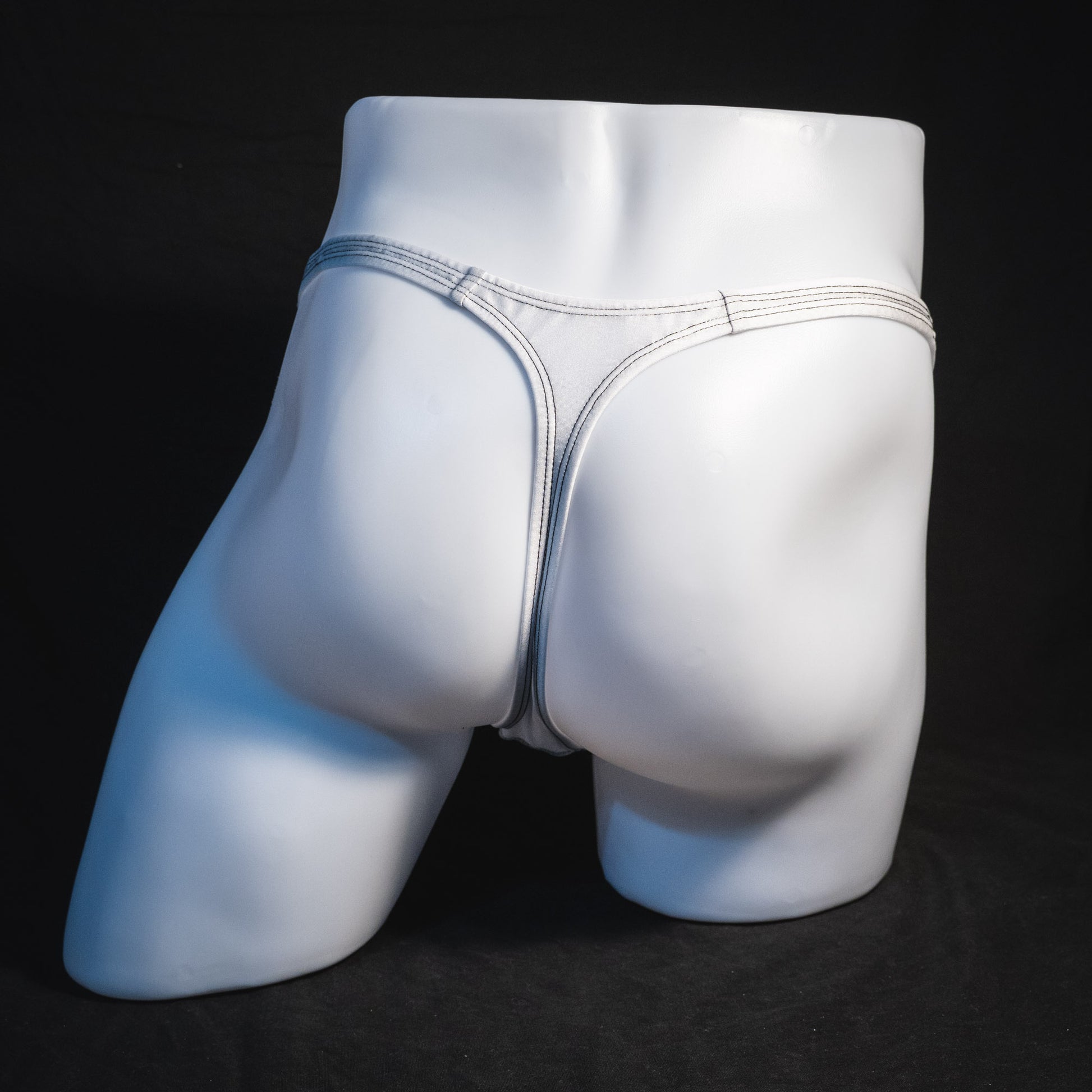 Men's white mesh thong underwear, classic cut, full rear view.