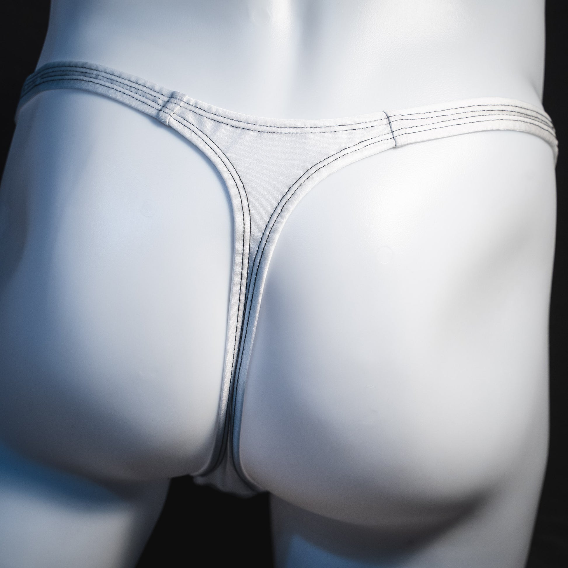 Men's white mesh thong underwear, classic cut, rear view.