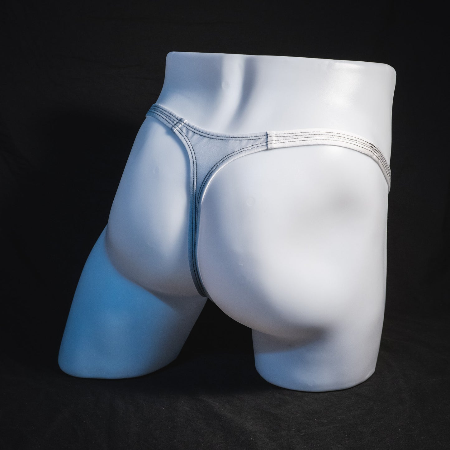 Men's white mesh thong underwear, classic cut, full angled rear view.