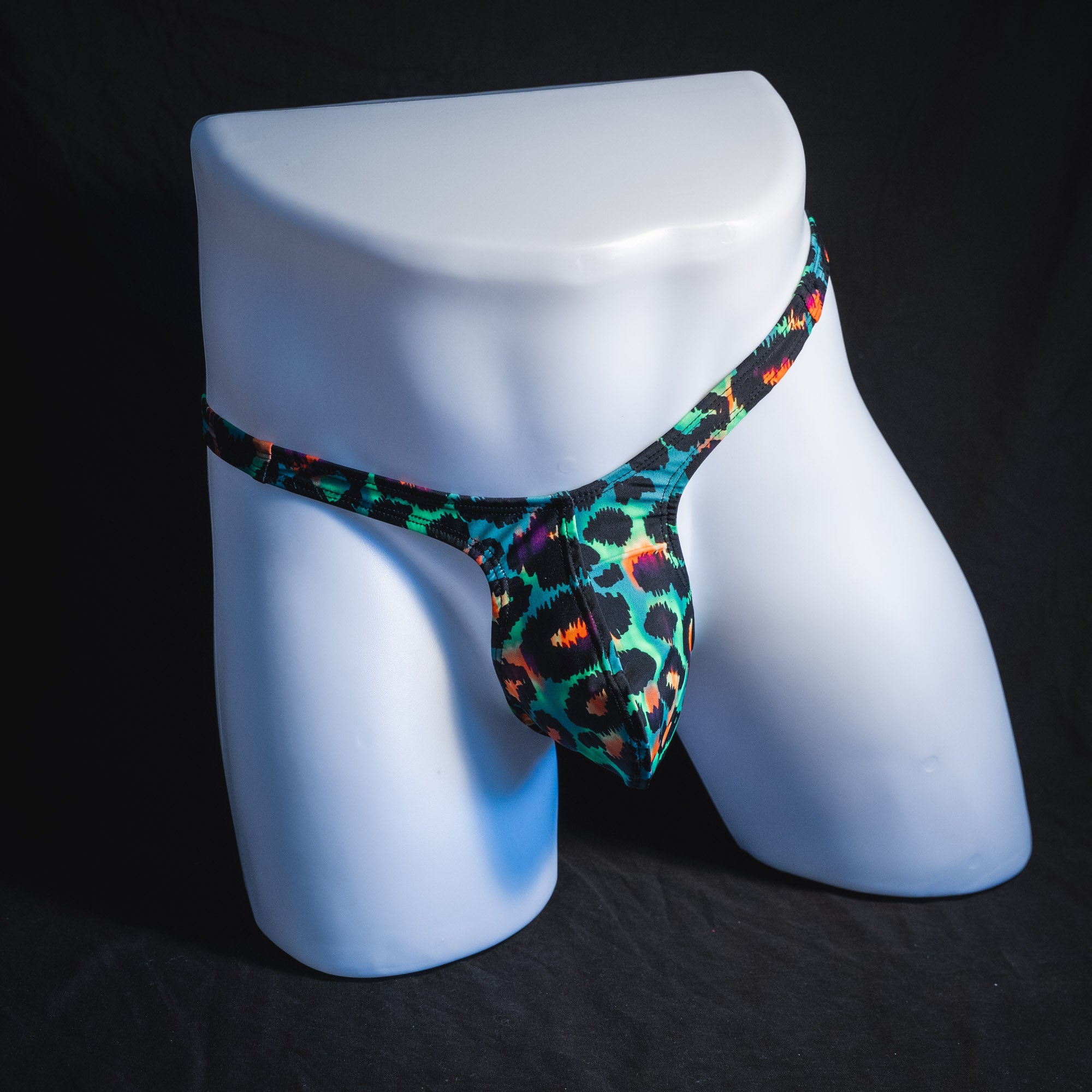 Men's wild green cheetah thong underwear, tower cut, front view.