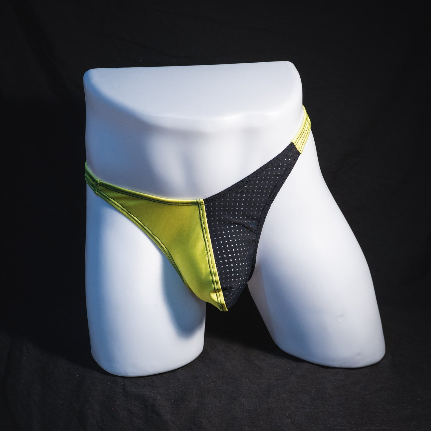 Men's yellow and black mesh thong underwear, classic cut, full front view.